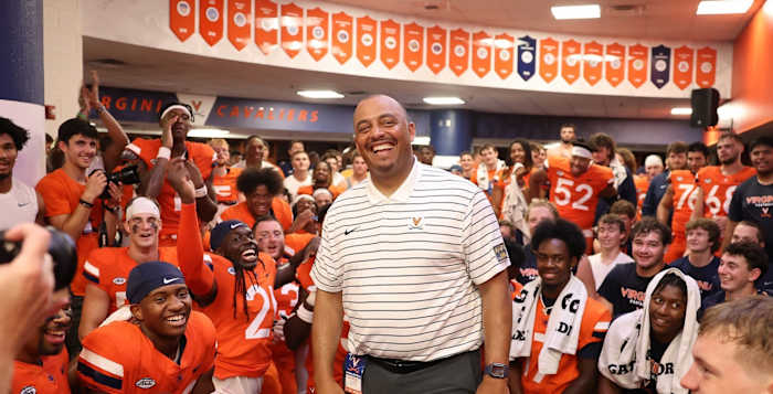 Virginia head coach Tony Elliott celebrates with his team after their victory over Richmond.